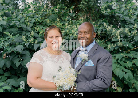 Mixed Race older couple getting married Stock Photo