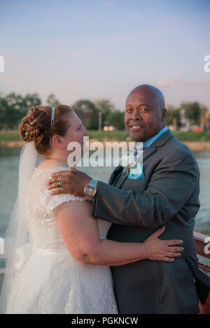 Mixed race older couple dancing Stock Photo