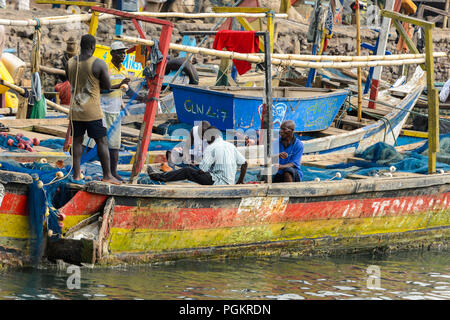 ELMINA, GHANA -JAN 18, 2017: Unidentified  Ghanaian people work in Elmina port. People of Ghana suffer of poverty due to the bad economy Stock Photo