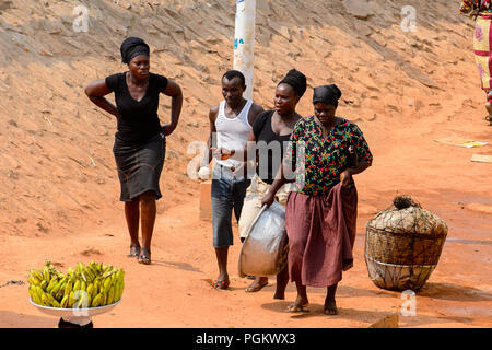 ELMINA, GHANA -JAN 18, 2017: Unidentified  Ghanaian people walk in Elmina. People of Ghana suffer of poverty due to the bad economy Stock Photo