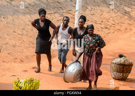 ELMINA, GHANA -JAN 18, 2017: Unidentified  Ghanaian people walk in Elmina. People of Ghana suffer of poverty due to the bad economy Stock Photo