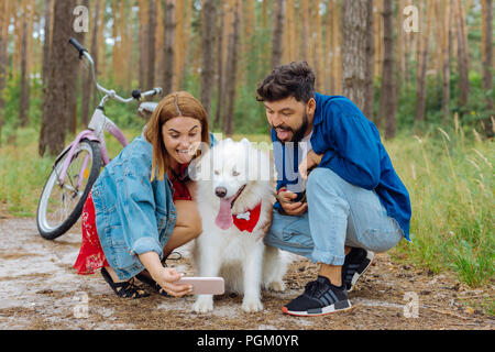 Cute couple making funny faces while making photo together Stock Photo