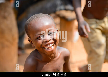 PIRA, BENIN - JAN 12, 2017: Unidentified Beninese little boy smiles. Benin children suffer of poverty due to the bad economy. Stock Photo