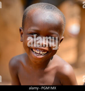 PIRA, BENIN - JAN 12, 2017: Unidentified Beninese little boy smiles. Benin children suffer of poverty due to the bad economy. Stock Photo