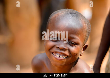 PIRA, BENIN - JAN 12, 2017: Unidentified Beninese little boy smiles. Benin children suffer of poverty due to the bad economy. Stock Photo