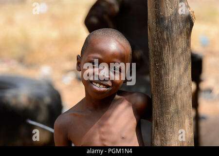 PIRA, BENIN - JAN 12, 2017: Unidentified Beninese little boy smiles. Benin children suffer of poverty due to the bad economy. Stock Photo