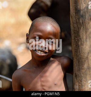 PIRA, BENIN - JAN 12, 2017: Unidentified Beninese little boy smiles. Benin children suffer of poverty due to the bad economy. Stock Photo