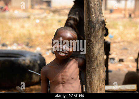 PIRA, BENIN - JAN 12, 2017: Unidentified Beninese little boy smiles. Benin children suffer of poverty due to the bad economy. Stock Photo