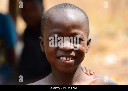 PIRA, BENIN - JAN 12, 2017: Unidentified Beninese little boy smiles. Benin children suffer of poverty due to the bad economy. Stock Photo