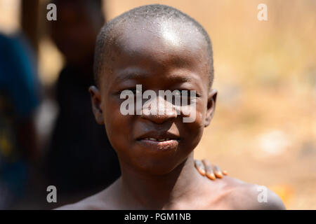 PIRA, BENIN - JAN 12, 2017: Unidentified Beninese little boy smiles. Benin children suffer of poverty due to the bad economy. Stock Photo