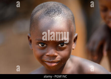 PIRA, BENIN - JAN 12, 2017: Unidentified Beninese little boy smiles. Benin children suffer of poverty due to the bad economy. Stock Photo