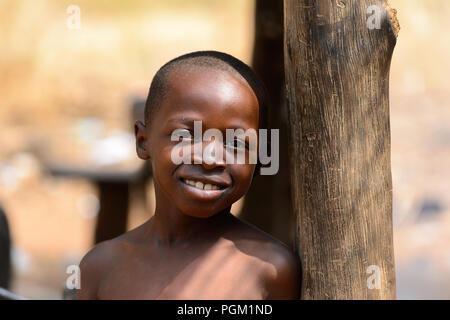 PIRA, BENIN - JAN 12, 2017: Unidentified Beninese little boy smiles. Benin children suffer of poverty due to the bad economy. Stock Photo