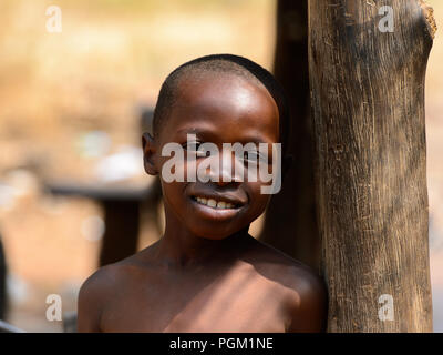 PIRA, BENIN - JAN 12, 2017: Unidentified Beninese little boy smiles. Benin children suffer of poverty due to the bad economy. Stock Photo