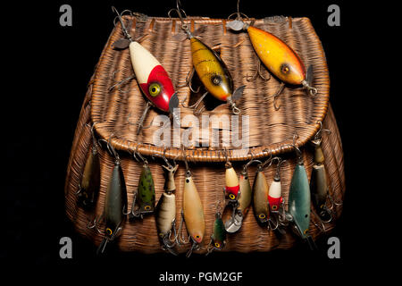 A selection of old fishing lures, or plugs, displayed on an old
