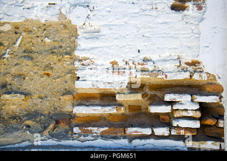 White brick wall with different structured surface Stock Photo