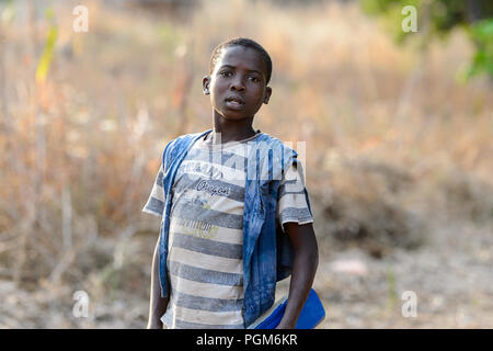 MASSIF KABYE, TOGO - JAN 13, 2017: Unidentified Togolese boy walks in the village. Togo people suffer of poverty due to the bad economy. Stock Photo