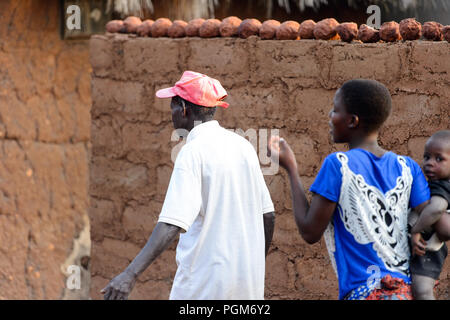 MASSIF KABYE, TOGO - JAN 13, 2017: Unidentified Togolese  men walk in the village. Togo people suffer of poverty due to the bad economy. Stock Photo