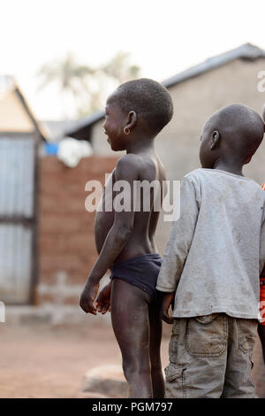 MASSIF KABYE, TOGO - JAN 13, 2017: Unidentified Togolese children stand in the village. Togo children suffer of poverty due to the bad economy. Stock Photo