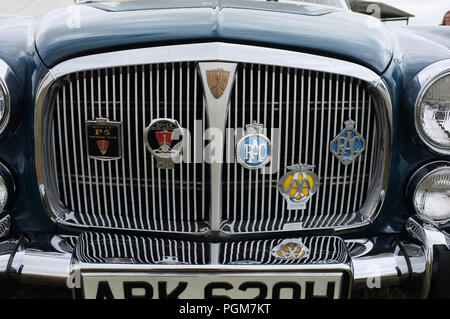 A close up image of a 1970 Rover P5B Coupe radiator grille with badges. 2018 Stock Photo