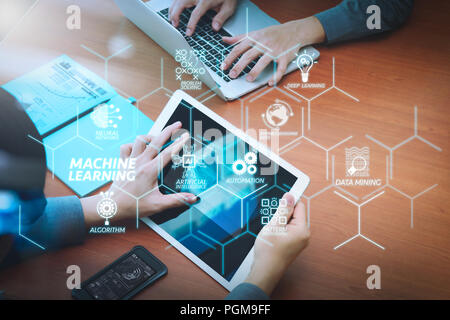 Machine learning technology diagram with artificial intelligence (AI),neural network,automation,data mining in VR screen. two colleagues using digital Stock Photo