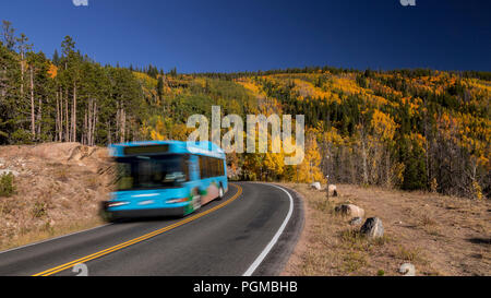 Shuttle bus on Bear Lake Road in the Rocky Mountain National Park, Colorado, USA with fall colors Stock Photo