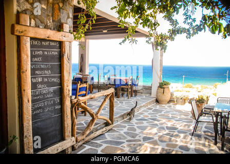 A Seasise Greek Taverna in Ios, Greece with the chalk menu-board outside. Stock Photo