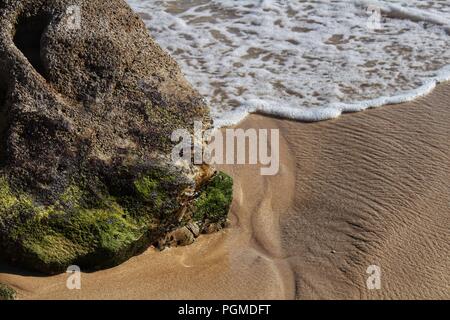 Crystalline waters and rock textures of Galapinhos Beach in Portugal Stock Photo