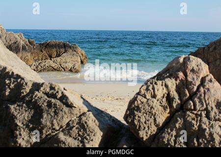 Crystalline waters, white sand and rock textures of Galapinhos Beach between mountains in Portugal Stock Photo