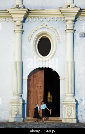 Women leaving Church of San Francisco in Granada, Nicaragua, Central America Stock Photo