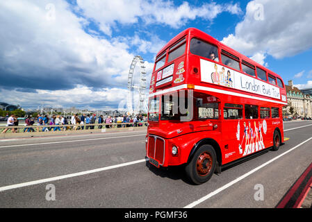London Bus Tour, red Routemaster bus. Brigit's Afternoon Tea aboard a London bus. Westminster Bridge Road with London Eye, Millennium Wheel Stock Photo