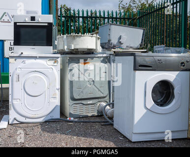 discarded old washing machines being recycled at a municipal dump or council tip. Stock Photo