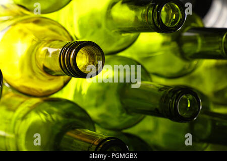 Close up stack of five empty washed green glass wine bottle necks, low angle side view Stock Photo