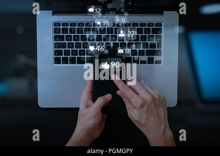 Social media and Marketing virtual icons screen concept.cyber security internet and networking concept.Businessman hand working mobile phone on laptop Stock Photo