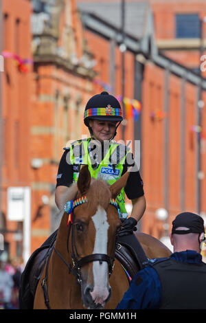 Female Greater Manchester Mounted Police Officers showing their support for the LGBT community as they take part in the 2018 Manchester Pride Parade. Stock Photo