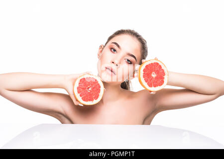 Beauty woman with orange citrus grapefruit with healthy skin body. Attractive fresh vitamin. Studio shot. Stock Photo