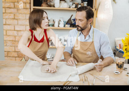 Couple of married potters working in the spacious workshop Stock Photo