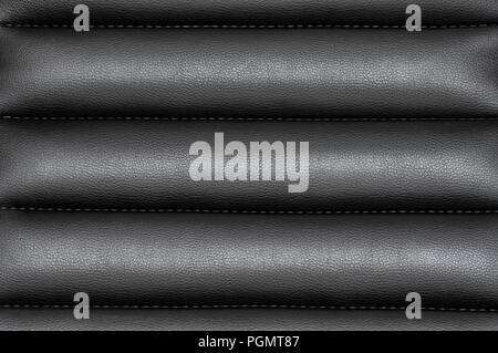 Black wavy leather background with seams Stock Photo