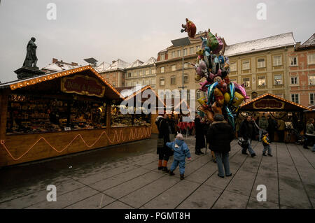 Shoppers in Hauptplatz, (main square) in Graz old town in Austria, shopping at the Christmas market. Stock Photo