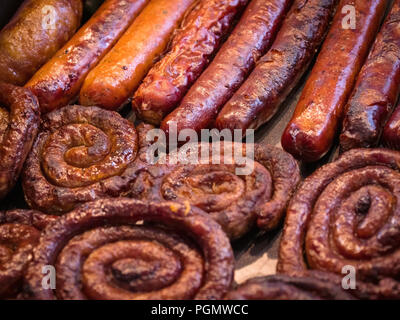 Grilling sausages on barbecue grill.