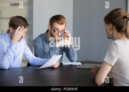 Unsure male recruiters considering female applicant candidature Stock Photo