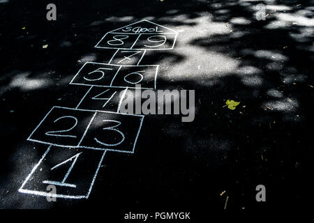 hopscotch drawn with chalk on the black asphalt Stock Photo