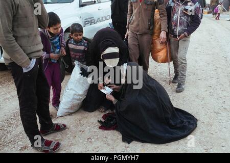 A refugee camp in Iraq, where live people escaped from ISIS. A just arrived woman ask information to find her relatives.