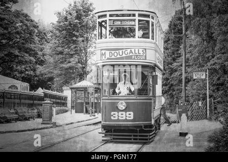 Crich Tramway Village 1940s event. Black & white vintage street scene, double decker tram travels along the line uniformed driver visible at controls. Stock Photo