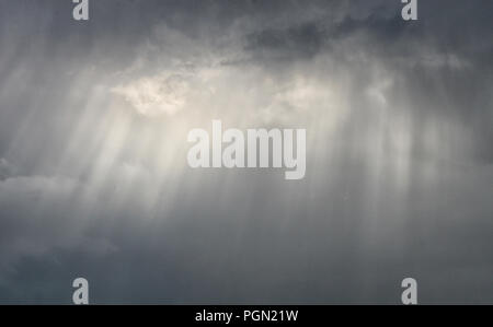 Sunshine coming through the gray clouds. Stock Photo