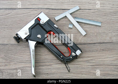 Do it yourself - Staplers and Staples DIY tools isolated on the wooden desk Stock Photo