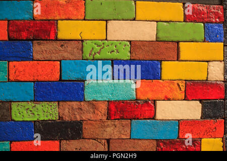 abstract aged multicolored painted baked earthen clay brick blocks, colorful architectural structure design, exterior wall background, wallpaper, back Stock Photo