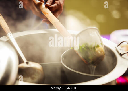 Thai Asian Street Food on rowing boat, fresh white rice Noodle Blanched in Noodle strainer basket with wood handle and warm aluminum stock boiler pot  Stock Photo