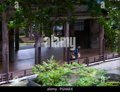 A monk bows as he passes in front of the Butsuden, or Buddha Hall, inside the grounds of Eiheiji Temple in Katsuyama, Fukui Prefecture, Japan on Oct.  Stock Photo