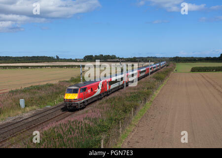 A London north eastern railways Intercity 225 train passing  Warkworth, Northumbria on the east coast main line with a Edinburgh to London train Stock Photo