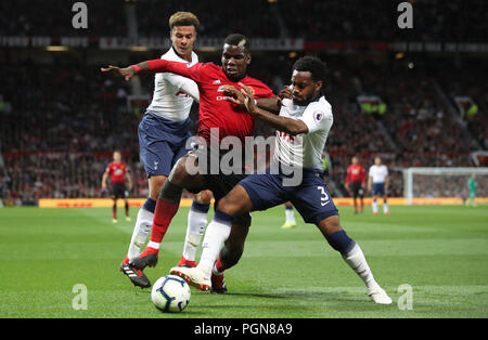 Manchester United's Paul Pogba (centre) and Tottenham Hotspur's Danny Rose and Dele Alli (left) battle for the ball during the Premier League match at Old Trafford, Manchester. Stock Photo